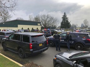 Police officers work the scene where a suspect was shot at a Cascade Middle School in Eugene, Ore, on Friday, Jan. 11, 2019. Eugene police Lt. Jennifer Bills told reporters that the incident began with a dispute outside the school. It wasn't clear who was involved and no further details were released.