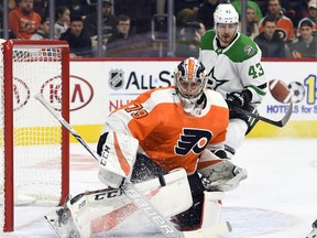 Philadelphia Flyers goaltender Carter Hart watches the puck after making a save in front of Dallas Stars' Valeri Nichushkin, rear, during the first period of an NHL hockey game Thursday, Jan. 10, 2019, in Philadelphia.