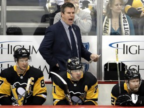 Pittsburgh Penguins head coach Mike Sullivan yells instructions from behind Sidney Crosby (87), Evgeni Malkin (71), and Patric Hornqvist (72) during the first period of the team's NHL hockey game against the Winnipeg Jets in Pittsburgh, Friday, Jan. 4, 2019. The Penguins won 4-0.