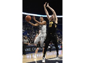 Penn State guard Rasir Bolton (13) shoots past Iowa forward Ryan Kriener (15) during the first half of an NCAA college basketball game Wednesday, Jan. 16, 2019, in State College, Pa.