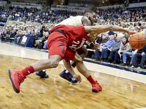 Louisville's Dwayne Sutton (24) tries to control the ball as Pittsburgh's Jared Wilson-Frame defends in the first half of an NCAA college basketball game, Wednesday, Jan. 9, 2019, in Pittsburgh.