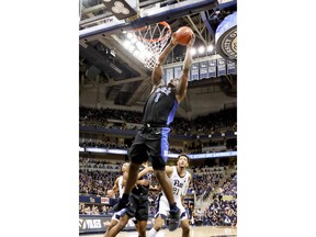 Duke's Zion Williamson (1) goes up for during a dunk in front of Pittsburgh's Terrell Brown (21) during the first half of an NCAA college basketball game, Tuesday, Jan. 22, 2019, in Pittsburgh.