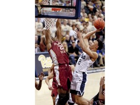 Pittsburgh's Trey McGowens (2) shoots as Florida State's Mfiondu Kabengele, left, defends during the first half of an NCAA college basketball game, Monday, Jan. 14, 2019, in Pittsburgh.