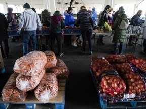 Philabundance volunteers distribute food to furloughed federal workers and their families who are affected by the partial government shutdown, under Interstate 95 in Philadelphia, Wednesday, Jan. 23, 2019.