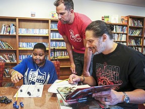 Hospital patient Yaheim Young, 15, of Penn Hills, Pa., left, Nick Manganiello, center, and his brother, Mt. Lebanon native and actor Joe Manganiello, right, count dice as they create their Dungeons and Dragons characters at UPMC Children's Hospital of Pittsburgh Tuesday, Jan. 8, 2019, in the Lawrenceville neighborhood.