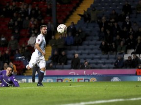 Blackburn's Adam Armstrong rounds Newcastle United's Freddie Woodman to score a goal during the Emirates FA Cup third round replay soccer match at Ewood Park, Blackburn, Tuesday Jan. 15, 2019.