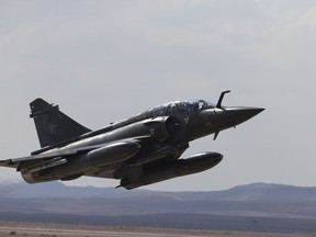 FILE - In this Wednesday, Nov. 8, 2017 file photo, a French Mirage 2000D jet fighter takes off from Ovda airbase near Eilat, southern Israel, during the 2017 Blue Flag exercise. A French fighter jet carrying two pilots has disappeared from radar screens near the Swiss border. A French air force spokeswoman said the Mirage 2000D was last detected Wednesday in a snow-covered mountainous area between the Doubs and Jura regions