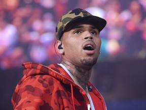 FILE - In this June 7, 2015 file photo, rapper Chris Brown performs at the 2015 Hot 97 Summer Jam at MetLife Stadium in East Rutherford, N.J. U.S. singer Chris Brown and two other people are in custody in Paris after a woman filed a rape complaint, French officials said Tuesday Jan.22, 2019.