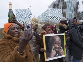 Supporters of former Ivory Coast President Laurent Gbagbo rally outside the International Criminal Court in The Hague, Netherlands, Tuesday, Jan. 15, 2019, where judges were expected to issue rulings on requests by Gbagbo and an ex-government minister Charles Bee Goude to have their prosecutions thrown out for lack of evidence.