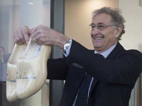 In a sign of the looming Brexit, Italy's Guido Rasi, director of the European Medicines Agency holds a pair of wooden shoes he was presented by Dutch Health Minster Bruno Bruins during the official opening of the agency's temporary headquarters in Amsterdam, Netherlands, Wednesday, Jan. 9, 2019. The London-based agency is moving to the Dutch capital after Brexit and is scheduled to move to the permanent location at Zuidas, Amsterdam's business district, later this year.