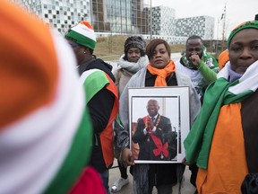 Supporters of former Ivory Coast President Laurent Gbagbo rally outside the International Criminal Court in The Hague, Netherlands, Tuesday, Jan. 15, 2019, where judges were expected to issue rulings on requests by Gbagbo and an ex-government minister Charles Ble Goude to have their prosecutions thrown out for lack of evidence.