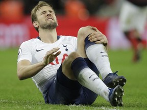 Tottenham's Harry Kane sits on the pitch with an injury after the English Premier League soccer match between Tottenham Hotspur and Manchester United at Wembley stadium in London, England, Sunday, Jan. 13, 2019.