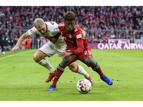 Stuttgart's Andreas Beck, left, and Munich's Kingsley Coman challenge for the ball during a German Bundsliga soccer match between Bayern Munich and VfB Stuttgart in Munich, Germany, Sunday, Jan.27, 2019.