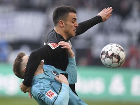 Frankfurt's Filip Kostic, right, holds back Freiburg's Lukas Kuebler as they vie for the ball during a Bundesliga soccer match between Eintracht Frankfurt and SC Freiburg in Frankfurt, Germany, Saturday, Jan.19, 2019.