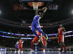 Philadelphia 76ers' Joel Embiid (21) goes up for a dunk during the first half of an NBA basketball game against the Washington Wizards, Tuesday, Jan. 8, 2019, in Philadelphia.