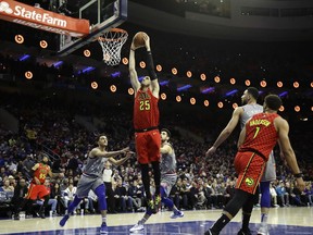 Atlanta Hawks' Alex Len (25) goes up for a dunk past Philadelphia 76ers' Landry Shamet (1) and Furkan Korkmaz (30) during the first half of an NBA basketball game Friday, Jan. 11, 2019, in Philadelphia.