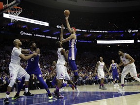 Philadelphia 76ers' Ben Simmons, right, goes up for a shot against Minnesota Timberwolves' Andrew Wiggins during the second half of an NBA basketball game, Tuesday, Jan. 15, 2019, in Philadelphia. Philadelphia won 149-107.