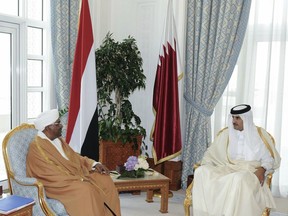 In this handout photo from Qatar News Agency, Sudanese President Omar al-Bashir, center left, meets with with Qatar's ruling emir, Sheikh Tamim bin Hamad Al Thani, in Doha Qatar, Wednesday, Jan. 23, 2019. Sudan's embattled president is in Qatar looking for support amid weekslong protests against his 29-year rule in the African nation. The two men are expected to discuss possible aid to Sudan, which is suffering from deep economic problems that sparked the protests. (Qatar News Agency via AP)