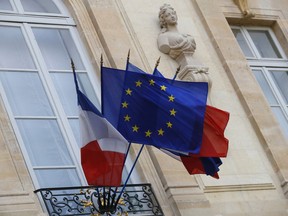 FILE - In this Monday, Dec. 10, 2018 file picture European and French flags are flapping at the Elysee Palace in Paris, during a meeting with French President Emmanuel Macron and local, national political leaders, unions, business leaders and others to hear their concerns after four weeks of protests. French Prime Minister Edouard Philippe announced Thursday that the government will start hiring 600 extra government employees including customs agents to handle cross-border trade and security.