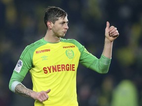In this his picture taken on Jan. 14, 2018, Argentine soccer player, Emiliano Sala, of the FC Nantes club, western France, gives a thumbs up during a soccer match against PSG in Nantes, France. The French civil aviation authority says Emiliano Sala was aboard a small passenger plane that went missing off the coast of the island of Guernsey.