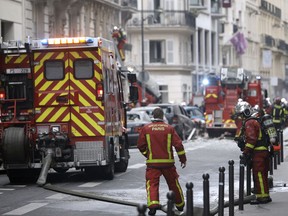 Firefighters work at the scene of a gas leak explosion in Paris, France, Saturday, Jan. 12, 2019. Paris police say several people have been injured in an explosion and fire at a bakery believed caused by a gas leak.