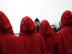 FILE - In this Saturday, Dec. 15, 2018 file picture, activists dressed like Marianne, a symbol of the French Republic, face riot police officers during a yellow vests protest, in Paris. Intolerance and conspiracy theories have haunted the margins of France's "yellow vest" movement since the first protests over fuel taxes roused the discontented middle of French society.