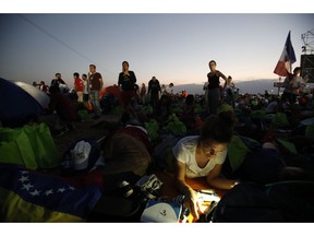Youth begin to wake after camping out in the metro park Campo San Juan Pablo II, in Panama City, Sunday, Jan. 27, 2019, where Pope Francis will celebrate an early morning Mass.