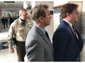Sen. Rand Paul, center, enters an elevator during a break in jury selection for his civil trial in Bowling Green, Ky., Monday, Jan. 28, 2019. Jury selection began Monday in Paul's lawsuit against Rene Boucher for the 2017 attack that left the senator with multiple broken ribs. Paul is seeking up to $500,000 in compensatory damages and up to $1 million in punitive damages.
