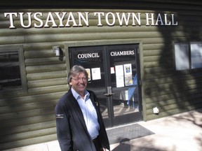 FILE - In this Nov. 1, 2017, file photo, Tusayan Mayor Craig Sanderson stands outside the town's office in Tusayan, Ariz. An off-grid housing project in a tiny town outside the Grand Canyon has come to a halt over a flood plain permit. Millions of tourists pass through Tusayan every year unaware of the decades of infighting over housing.