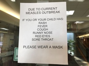 Signs posted at The Vancouver Clinic in Vancouver, Wash., warn patients and visitors of a measles outbreak on Wednesday, Jan. 30, 2019. The outbreak has sickened 39 people in the Pacific Northwest, with 13 more cases suspected. At least one patient who was sick with the measles has come to this clinic for treatment since the outbreak began Jan. 1, 2019.