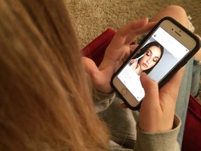 In this Nov. 1, 2018 photo, Laurel Foster looks at Instagram in San Francisco. App developers say as teens scroll through Instagram and Snapchat, tap out texts, or hole up in their rooms watching YouTube, they're leaving enormous digital footprints that may offer clues to their psyches. Studies are under way to find out.