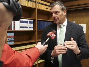 FILE - In this Nov. 30 2018 file photo, former Kansas Secretary of State Kris Kobach answers questions from reporters in Topeka, Kan. The future of a contentious multi-state voter registration database is uncertain now that former Kansas Secretary of State Kobach no longer holds that office. A spokeswoman for Kansas Secretary of State Scott Schwab said Friday, Jan. 18, 2019, the office is reviewing Interstate Voter Registration Crosscheck Program and consulting with other member states.