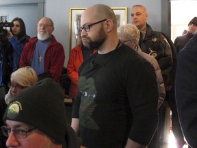 Max Misch, center, a white nationalist who harassed former Vermont legislator Kiah Morris, attends a news conference Monday, Jan. 14, 2019, in Bennington, Vt., about the attorney general's investigation into the racial threats against her. Morris, who became the state's first black female lawmaker in 2014, resigned last year after receiving threats that caused her to fear for the safety of herself and her family. Misch said after the press conference that he's an online troll out of boredom and because "it's fun."