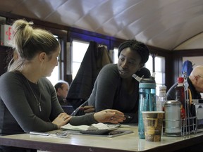In this Friday, Jan. 25, 2019, waitress Kelcie Tipping, left, speaks with fellow waitress Mariam Touray, right, at the Modern Diner in Pawtucket, R.I. A large majority of Americans say they are pessimistic about the state of the country and few expect things will get better in the year ahead, according to a poll released Tuesday by The Associated Press-NORC Center for Public Affairs Research.