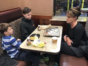 In this Jan. 10, 2019, photo, Tamra Cartwright, right, talks with sons Connor, 7, left, and Caden, 11, about the effect of multiple aftershocks from Alaska's recent magnitude 7.0 earthquake while interviewed in Anchorage, Alaska. Connor Cartwright says the aftershocks terrify him, and he fears his Anchorage home won't hold up.