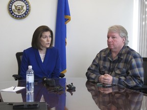 David Pritchett, a furloughed worker for the U.S. Bureau of Land Management, looks on as Sen. Catherine Cortez Masto, D-Nev., talks to reporters Friday, Jan. 11, 2019, in her office in Reno about the impacts of the partial government shutdown. Pritchett, a BLM planner in Reno, says the effects of the shutdown will have a ripple effect on federal land management long after the government fully reopens because of deadlines that were missed for federal permits on a whole range of projects, from gold mines to large recreational events.