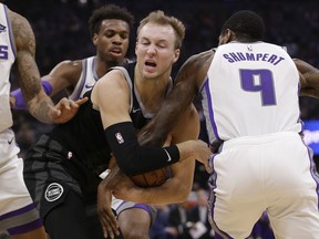 Detroit Pistons guard Luke Kennard, front left, tries to keep the ball from Sacramento Kings guard Iman Shumpert, right, during the first quarter of an NBA basketball game Thursday, Jan. 10, 2019, in Sacramento, Calif.