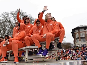 Clemson quarterback Trevor Lawrence, right, along with fellow freshman ride in the parade honoring Clemson Saturday, Jan. 12, 2019, in Clemson, S.C., Clemson defeated Alabama 44-16 in the College Football Playoff championship game Monday Jan. 7.