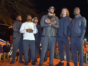 Clemson's Christian Wilkins, Adam Choice, Hunter Renfrow, Clelin Ferrell, Trevor Lawrence and Trayvon Mullen, from left, stand on a stage after the team returned to campus Tuesday, Jan. 8, 2019, in Clemson, S.C., the day after a 44-16 win over Alabama in the College Football Playoff championship game.