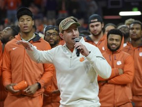 Clemson head football coach Dabo Swinney along with members of the 2019 National Championship football team address the crowd during the first half of an NCAA college basketball game between Clemson and Virginia, Saturday, Jan. 12, 2019, in Clemson, S.C.