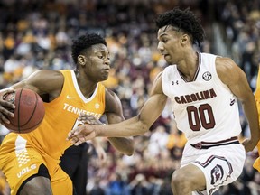 Tennessee guard Admiral Schofield, left, drives to the hoop against South Carolina guard A.J. Lawson (00) during the first half of an NCAA college basketball game Tuesday, Jan. 29, 2019, in Columbia, S.C.