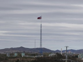 FILE - In this April 27, 2018, file photo, a North Korean flag flutters in the wind atop a 160-meter tower in North Korea's village Gijungdongseen, as seen from the Taesungdong freedom village inside the demilitarized zone in Paju, South Korea. South Korea's spy agency on Thursday, Jan. 3, 2019, has told lawmakers that North Korea's acting ambassador to Italy Jo Song Gil went into hiding with his wife in November.