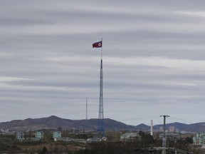 FILE - In this April 27, 2018, file photo, a North Korean flag flutters in the wind atop a 160-meter tower in North Korea's village Gijungdongseen, as seen from the Taesungdong freedom village inside the demilitarized zone in Paju, South Korea. South Korea has stopped calling North Korea an "enemy" in its biennial defense document published Tuesday, Jan. 15, 2019 in an apparent effort to continue reconciliation with Pyongyang. The development comes as U.S. and North Korean leaders are looking to set up their second summit to defuse an international standoff over the North's nuclear program.