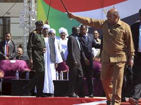 Sudan's President Omar al-Bashir greets his supporters at a rally in Khartoum, Sudan, Wednesday, Jan. 9, 2019. Al-Bashir told the gathering of several thousands of supporters in the capital that he is ready to step down only "through election." The remarks come after three weeks of anti-government protests.