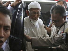 FIEL - In this March 1, 2018, file photo, ailing radical cleric Abu Bakar Bashir, center, arrives for medical treatment at Cipto Mangunkusumo Hospital in Jakarta, Indonesia. A lawyer for the ailing radical cleric who inspired the Bali bombers said Friday, Jan. 18, 2019, the Indonesian government will release him from prison next week.