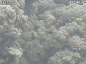 In this image from a surveillance camera released by Japan Meteorological Agency, a smoke column rises after an eruption of Shindake volcano in Kuchinoerabu island, southern Japan, Thursday, Jan. 17, 2019. Japan Meteorological Agency said Thursday's eruption of Shindake volcano caused volcanic rocks flying out of the crater and pyroclastic flows pouring down but have not reached as far as the residential area 2 kilometers (1.2 mile) away. (Japan Meteorological Agency via AP)