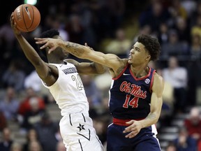 Mississippi forward KJ Buffen (14) defends against Vanderbilt forward Aaron Nesmith (24) in the first half of an NCAA college basketball game Saturday, Jan. 5, 2019, in Nashville, Tenn.