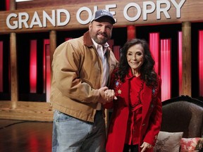 Country music legend Loretta Lynn and country star Garth Brooks leave the stage of the Grand Ole Opry House, Monday, Jan. 14, 2019, in Nashville, Tenn., after Lynn announced she will celebrate her 87th birthday with an all-star tribute concert featuring Brooks, Jack White, George Strait and others on April 1.