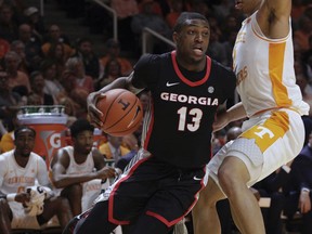 Georgia forward E'Torrion Wilridge (13) drives the ball against Tennessee forward Grant Williams (2) in the first half of an NCAA college basketball game Saturday, Jan. 5, 2019, in Knoxville, Tenn.