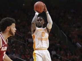 Tennessee guard Jordan Bone (0) attempts a shot over Alabama's defense in the second half of an NCAA college basketball game, Saturday, Jan. 19, 2019, in Knoxville, Tenn. Tennessee won 71-68